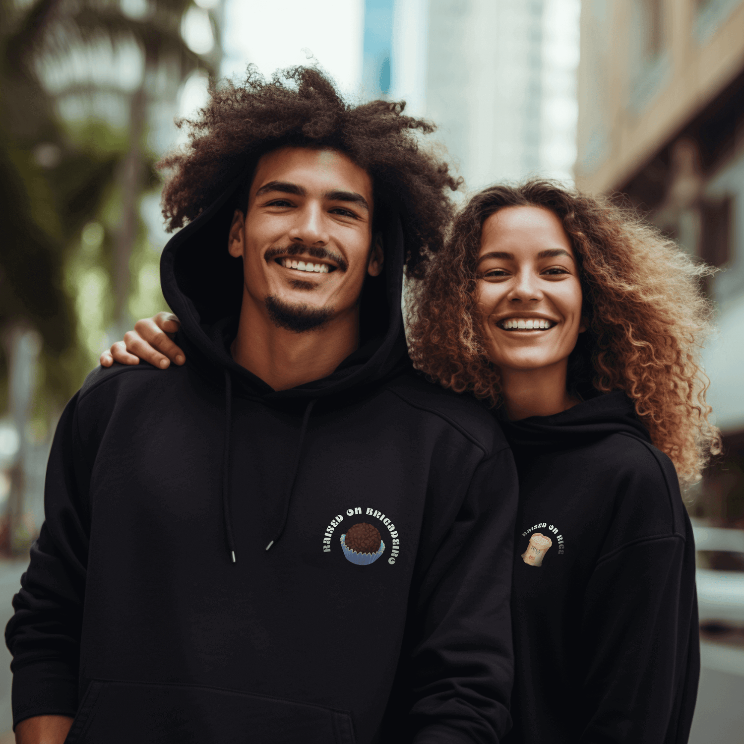 Two multi-cultural models wearing Lokal Coco's Raised on Brigadeiro and Raised on Rice hoodies.